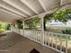 Inviting porch with railings offering serene views of the surrounding neighborhood and lush greenery at 3215 W Orangewood Ave, Phoenix, AZ 85051