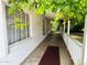 Covered porch featuring a classic white railing, greenery and a view of the surrounding landscape at 3215 W Orangewood Ave, Phoenix, AZ 85051