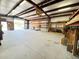 Open workshop with metal beams, shelving units, and a spacious layout ideal for projects and storage at 3215 W Orangewood Ave, Phoenix, AZ 85051