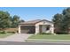 Charming single-story home showcasing a well-manicured front yard and a two-car garage at 3283 E Outlaw Ln, San Tan Valley, AZ 85140