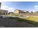 Spacious backyard features a pool, lawn, and privacy fence, creating a relaxing and private outdoor space at 3491 N 301St Dr, Buckeye, AZ 85396