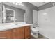 Bathroom with a modern vanity, toilet, and a tub-shower combo with bright white tile at 3491 N 301St Dr, Buckeye, AZ 85396
