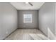 Clean and well-lit bedroom space with tile floors and a window providing natural light at 3491 N 301St Dr, Buckeye, AZ 85396