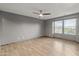 Large bedroom with tile floors, ceiling fan, and dual windows, provides ample natural light at 3491 N 301St Dr, Buckeye, AZ 85396