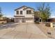 Two-story home with a light stucco exterior, two-car garage, and a concrete driveway at 3491 N 301St Dr, Buckeye, AZ 85396
