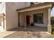 Covered front porch with decorative columns, a red front door, and gravel landscaping at 3491 N 301St Dr, Buckeye, AZ 85396