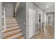 Hallway with wooden stairs and access to a laundry room offering both functionality and style at 3491 N 301St Dr, Buckeye, AZ 85396
