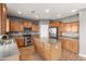 Well-lit kitchen with stainless steel appliances, center island, and granite countertops at 3491 N 301St Dr, Buckeye, AZ 85396