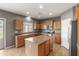 Kitchen features stainless steel appliances, a center island, and wooden cabinetry at 3491 N 301St Dr, Buckeye, AZ 85396