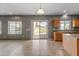 Open kitchen with an island, stainless appliances, tile floors, and access to the backyard at 3491 N 301St Dr, Buckeye, AZ 85396