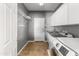Well-organized laundry room featuring modern appliances, granite countertop, and ample storage space at 3491 N 301St Dr, Buckeye, AZ 85396
