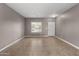 Living room with tile flooring, natural light and white interior door at 3491 N 301St Dr, Buckeye, AZ 85396