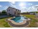 Backyard features a lagoon-shaped pool with an elegant, textured surround, offering a resort-like experience at 3491 N 301St Dr, Buckeye, AZ 85396