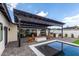 Inviting backyard featuring a pool, fire pit, outdoor kitchen, and covered seating area at 3502 N Rose Circle Dr, Scottsdale, AZ 85251