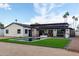Wide backyard with pool, outdoor kitchen, artificial turf, and dark pergola at 3502 N Rose Circle Dr, Scottsdale, AZ 85251