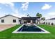 Expansive backyard with a pool, fire pit, outdoor kitchen, and lush artificial turf at 3502 N Rose Circle Dr, Scottsdale, AZ 85251