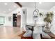 Bright dining room with round table, modern light fixture, and bar area at 3502 N Rose Circle Dr, Scottsdale, AZ 85251