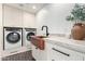 Convenient laundry room with modern appliances, ample storage, and a stylish sink at 3502 N Rose Circle Dr, Scottsdale, AZ 85251