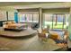 Bright bedroom with a sitting area and a large window with views of the outside at 351 E Thomas Rd # D106, Phoenix, AZ 85012