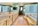 Bright bathroom with double sinks, wood cabinets, tiled floors, and lots of light at 36721 N 17Th Ave, Phoenix, AZ 85086