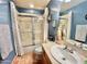 Well-lit bathroom featuring a shower and tub combination with sliding glass doors at 36721 N 17Th Ave, Phoenix, AZ 85086