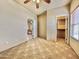 Spacious bedroom with a ceiling fan, closet, and view into the living room at 36721 N 17Th Ave, Phoenix, AZ 85086