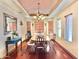 Dining room with a wood table, ornate chairs, wood floors and a tray ceiling at 36721 N 17Th Ave, Phoenix, AZ 85086