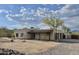 Exterior view of a tan stucco home in a desert landscape with mountain views at 36721 N 17Th Ave, Phoenix, AZ 85086