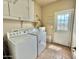 Laundry room featuring a washer, dryer, and plenty of storage space at 36721 N 17Th Ave, Phoenix, AZ 85086