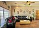 Open-concept living room featuring Saltillo tile floors, a leather sofa, and light-colored walls at 36721 N 17Th Ave, Phoenix, AZ 85086
