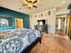 Bright main bedroom with blue accent wall, beamed ceiling, and en-suite bathroom access at 36721 N 17Th Ave, Phoenix, AZ 85086
