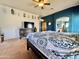 Bright main bedroom with blue accent wall, beamed ceiling, and en-suite bathroom access at 36721 N 17Th Ave, Phoenix, AZ 85086