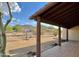 Spacious covered patio with natural wood posts offering serene views of desert landscape at 36721 N 17Th Ave, Phoenix, AZ 85086