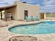 Inviting private pool surrounded by stone pavers with views of desert landscape and patio seating at 36721 N 17Th Ave, Phoenix, AZ 85086
