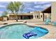 Backyard pool with floaties and lounge chairs next to a charming stucco home with blue skies at 36721 N 17Th Ave, Phoenix, AZ 85086