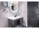 Powder room with dark vanity, decorative mirror, and modern fixtures at 4243 E Jasper Dr, Gilbert, AZ 85296