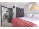 Comfortable bedroom featuring soft grey tones, closet, and a view to the exterior and living spaces at 4243 E Jasper Dr, Gilbert, AZ 85296