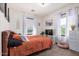 Bright bedroom with orange bedspread, two windows with sheer curtains and a fluffy dog bed at 4243 E Jasper Dr, Gilbert, AZ 85296