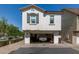 Facade of a two story home with open garage, and a driveway at 4243 E Jasper Dr, Gilbert, AZ 85296