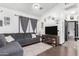Comfortable living room with dark gray couch and dark wood floors with modern decor at 4243 E Jasper Dr, Gilbert, AZ 85296