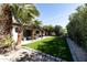 Landscaped backyard with artificial grass and a covered patio area perfect for outdoor dining and relaxation at 4317 E Ludlow Dr, Phoenix, AZ 85032