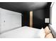 Comfortable bedroom with a black ceiling, bright white closet doors, and stylish modern decor at 4317 E Ludlow Dr, Phoenix, AZ 85032