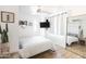 Bright bedroom featuring wood floors, ceiling fan, mounted television, and modern decor at 4317 E Ludlow Dr, Phoenix, AZ 85032
