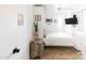 Bright bedroom with wood floors, ceiling fan, mounted television, and rustic wood night stand at 4317 E Ludlow Dr, Phoenix, AZ 85032