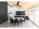 Open-concept dining room featuring black cabinets, stainless appliances, and concrete floors at 4317 E Ludlow Dr, Phoenix, AZ 85032