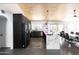 Bright kitchen featuring stainless steel appliances, quartz counters, concrete floors, and black cabinets at 4317 E Ludlow Dr, Phoenix, AZ 85032
