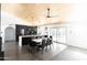 Modern kitchen with stainless steel appliances, a quartz waterfall island, and a dining table at 4317 E Ludlow Dr, Phoenix, AZ 85032