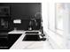 Modern kitchen with black cabinets, quartz countertops, a gold faucet, and stainless steel appliances at 4317 E Ludlow Dr, Phoenix, AZ 85032