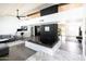 Spacious living room with modern fireplace, concrete floors, and wooden plank ceiling at 4317 E Ludlow Dr, Phoenix, AZ 85032