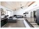 Bright living room featuring concrete floors, a wooden ceiling, modern furniture, and office space at 4317 E Ludlow Dr, Phoenix, AZ 85032